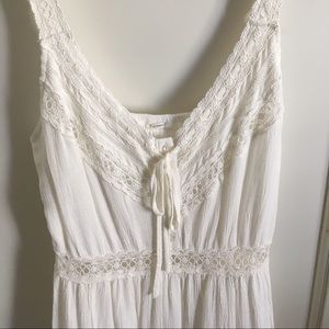 Long White Dress with V-Neck and Floral Cutouts